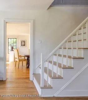 a view of entryway and hall with wooden floor