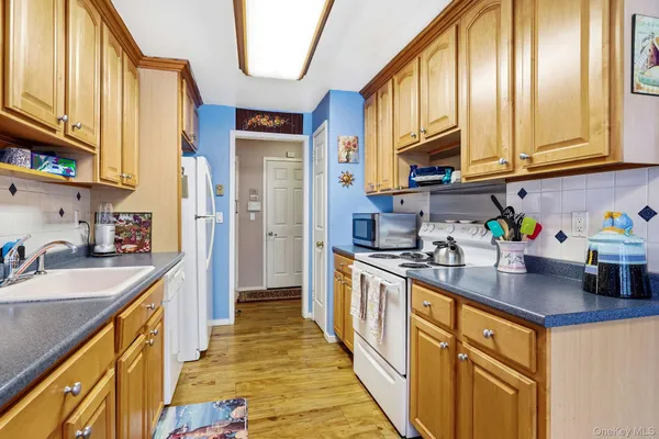 a kitchen with stainless steel appliances granite countertop a sink a stove and a refrigerator