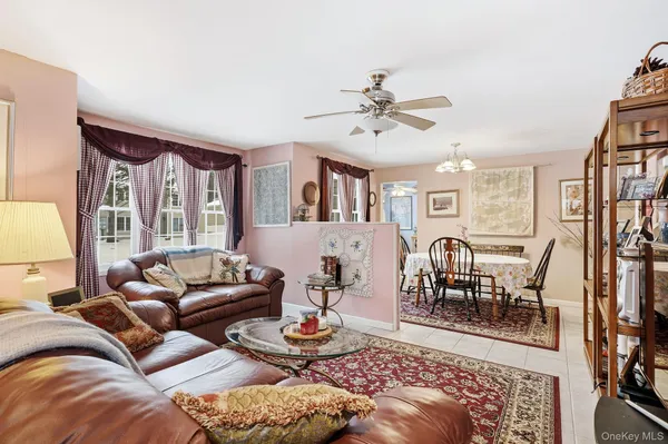 a living room with furniture fireplace and a large window