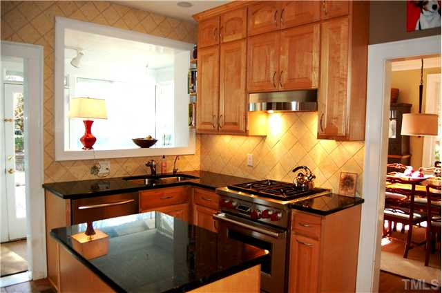 118 Hudson Street Raleigh, NC 27608 - Photo 5 of 12 WOW!!! What a kitchen...updated with lots of cabinets, granite countertops and stainless appliances including a wolf gas dual fuel range! Grand views through the sunroom of the backyard! Kitchen