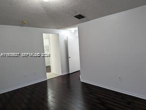 8719 Southwest 158th Path Miami, FL 33193 - Photo 11 of 13 an empty room with wooden floor