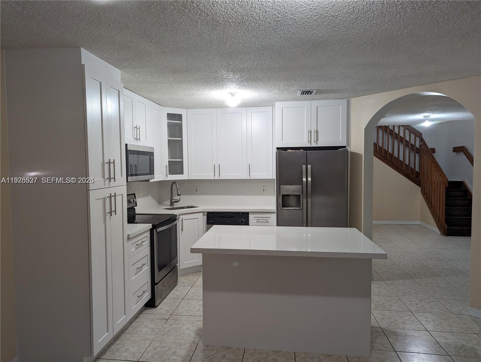 8719 Southwest 158th Path Miami, FL 33193 - Photo 2 of 13 a large kitchen with cabinets and stainless steel appliances
