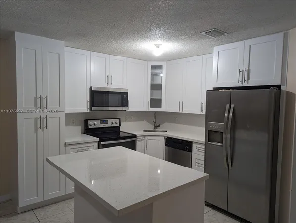 a kitchen with a refrigerator stove and microwave