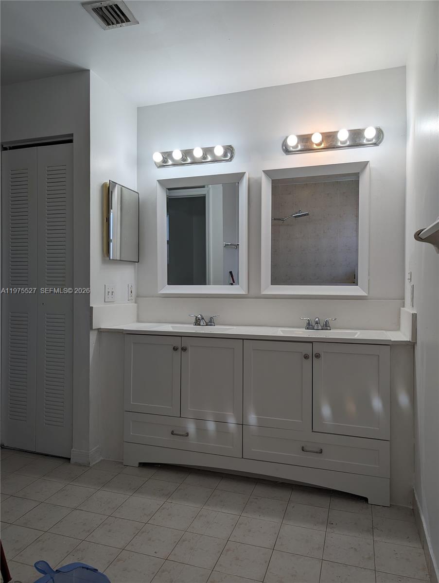 8719 Southwest 158th Path Miami, FL 33193 - Photo 8 of 13 a bathroom with a sink vanity and mirror