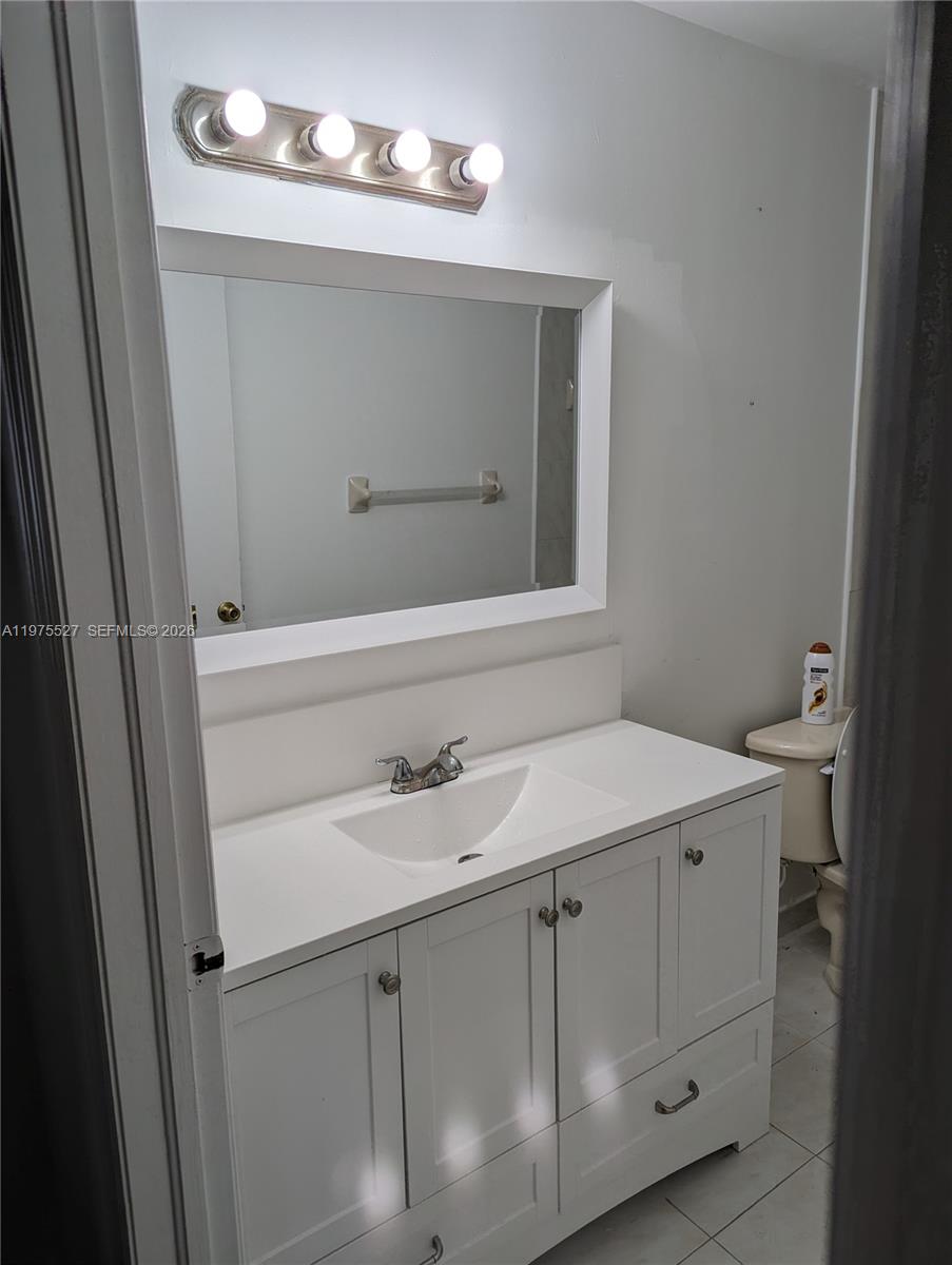 8719 Southwest 158th Path Miami, FL 33193 - Photo 9 of 13 a bathroom with a sink and a mirror