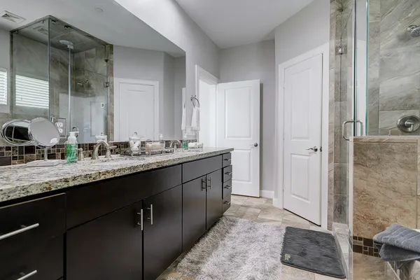 a bathroom with a double vanity sink and a mirror