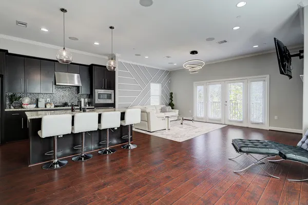 a living room with furniture and kitchen view