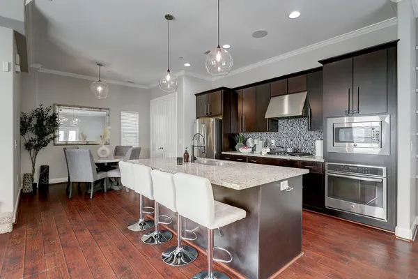 a large kitchen with a table and chairs