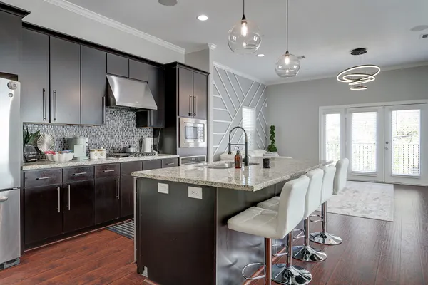 a kitchen with stainless steel appliances kitchen island granite countertop a sink and cabinets