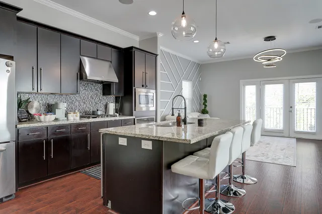 a kitchen with stainless steel appliances kitchen island granite countertop a sink and cabinets