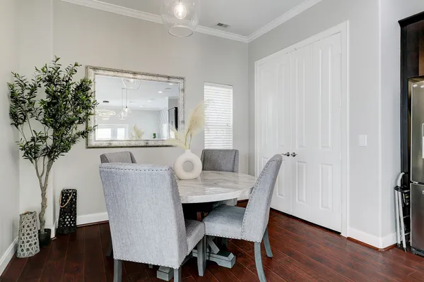 a dining room with furniture and wooden floor