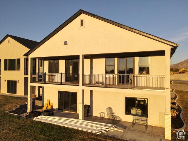 657 North Heritage Street, Unit 9 Mapleton, UT 84664 - Photo 2 of 10 Rear view of house featuring stucco siding, a patio area, and a balcony