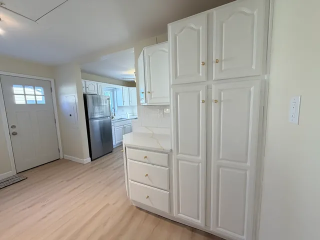 a kitchen with stainless steel appliances granite countertop a stove a sink dishwasher and a refrigerator