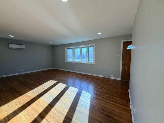 a view of wooden floor and windows in a room