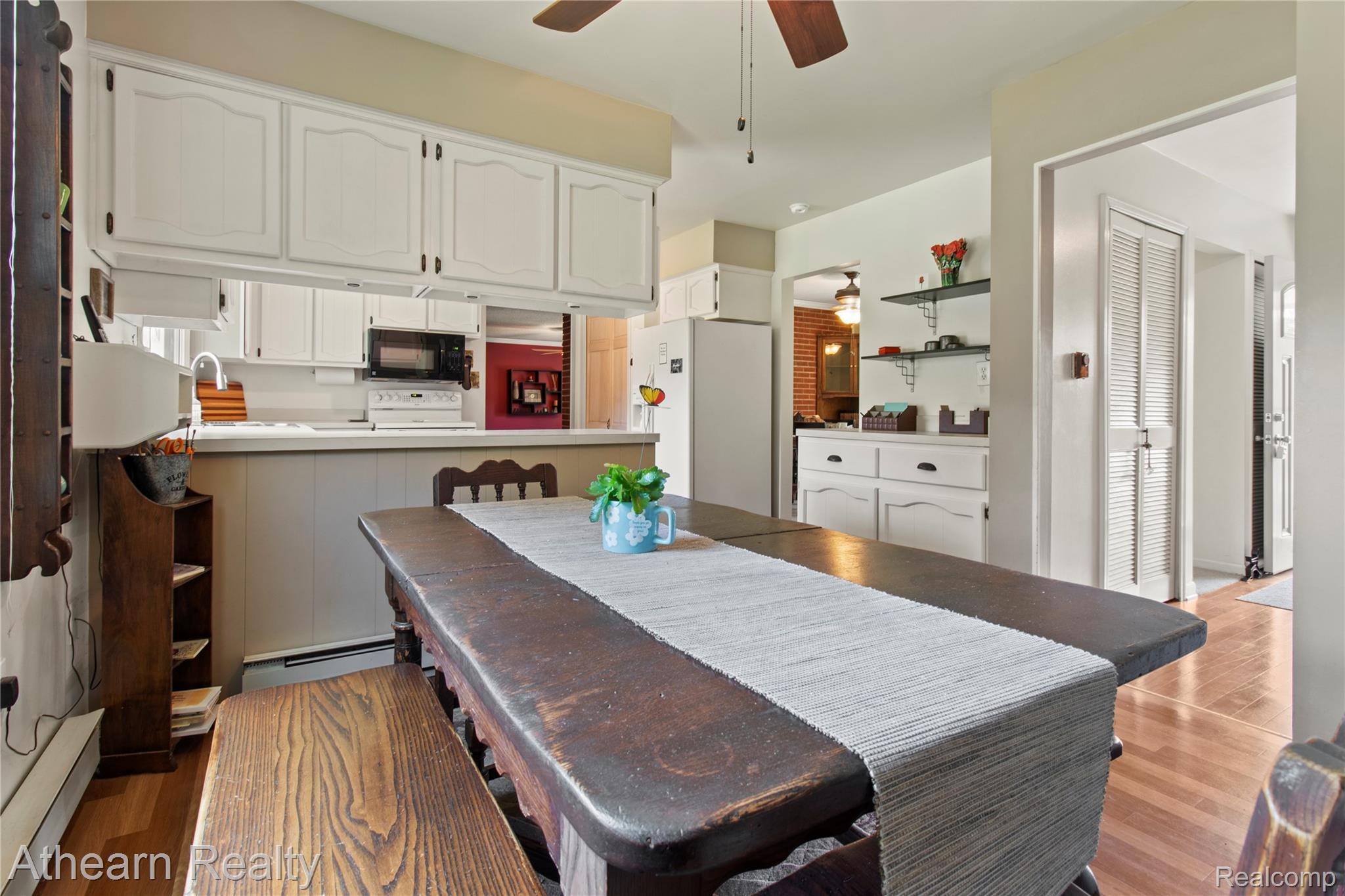 12427 Foley Road Fenton, MI 48430 - Photo 23 of 47 Kitchen featuring white cabinetry, white appliances, wood-finish flooring, and a ceiling fan