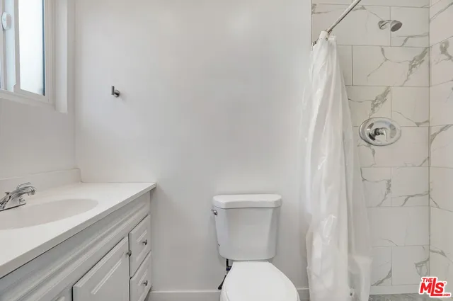 a white toilet sitting next to a bathroom sink