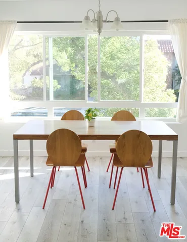 a view of a dining room with furniture and a large window