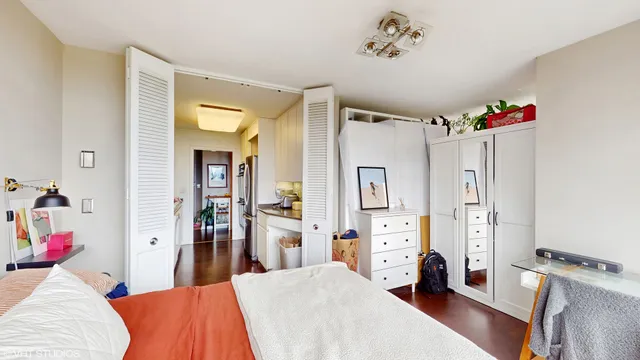 a bedroom with a large bed and a large window