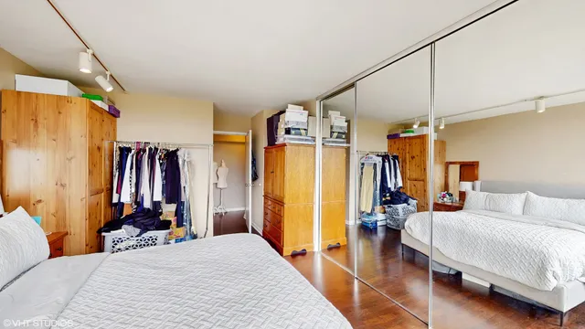 a bedroom with a large bed and a large window