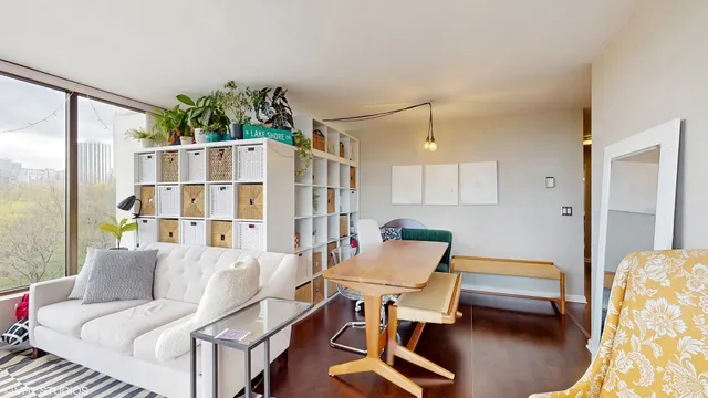 a living room with furniture a rug and a large window