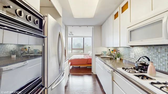 a kitchen with a sink stove and refrigerator