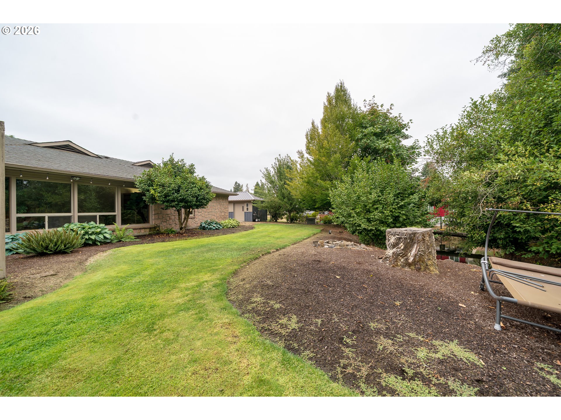455 West High Street Stayton, OR 97383 - Photo 39 of 48 a view of a backyard with a garden and entertaining space