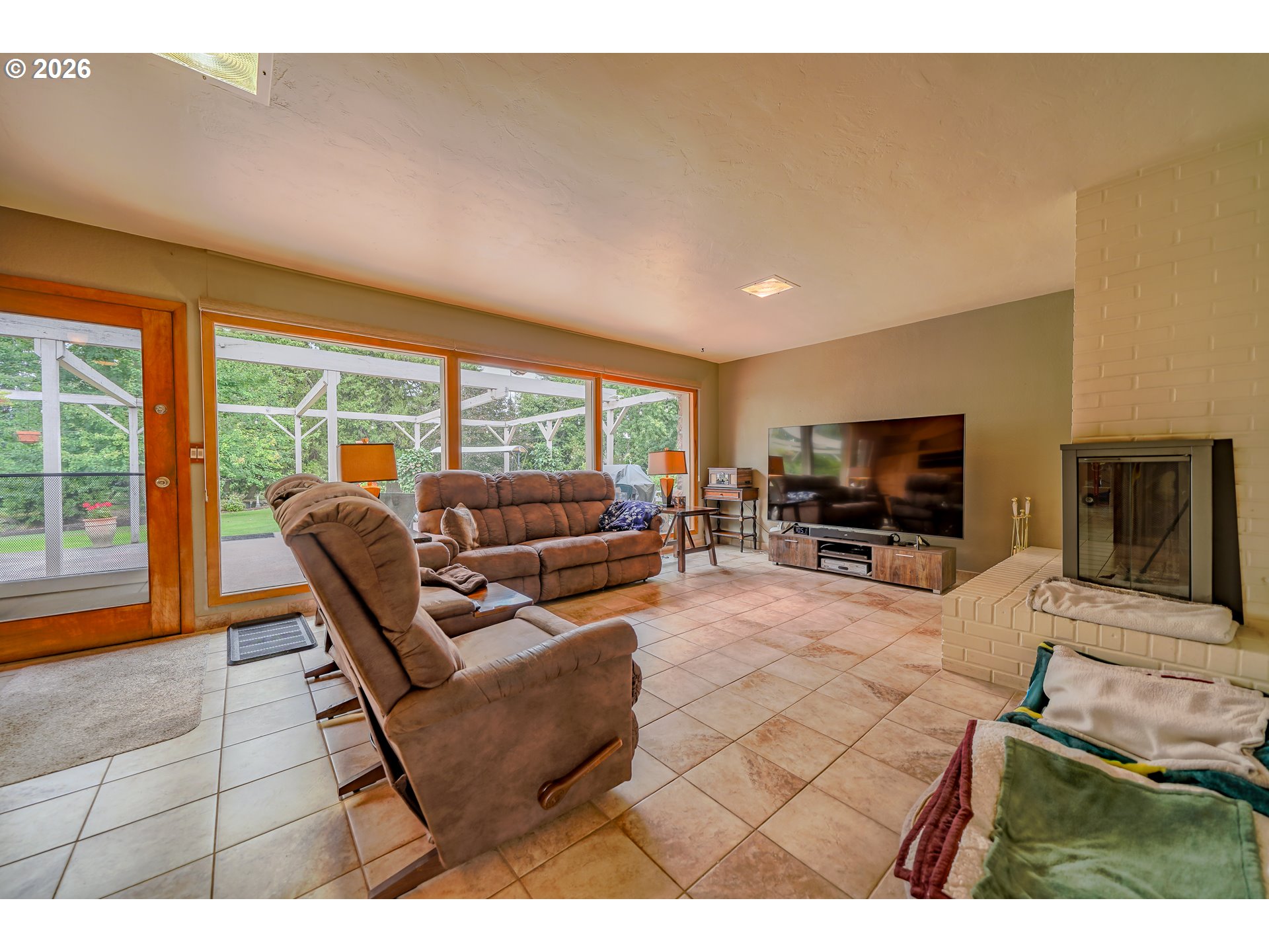 455 West High Street Stayton, OR 97383 - Photo 5 of 48 a living room with furniture a flat screen tv and a large window