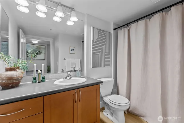 a bathroom with a sink a toilet and mirror