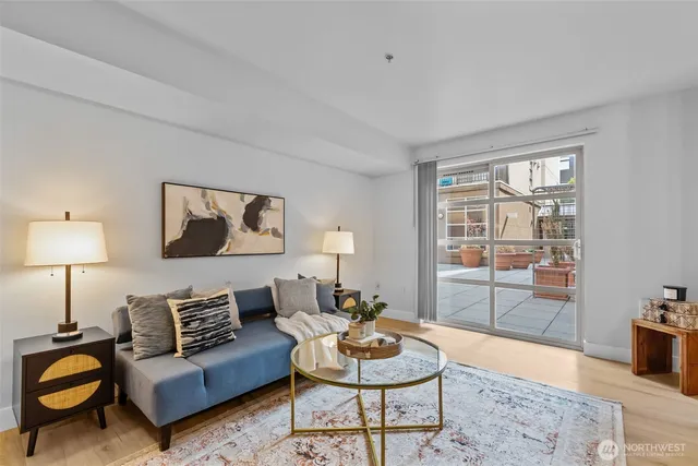 a living room with furniture a lamp and a window