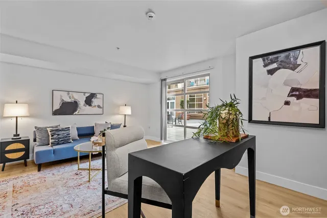 a living room with furniture and a lamp