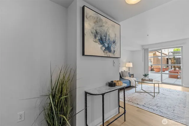 a living room with furniture and a potted plant