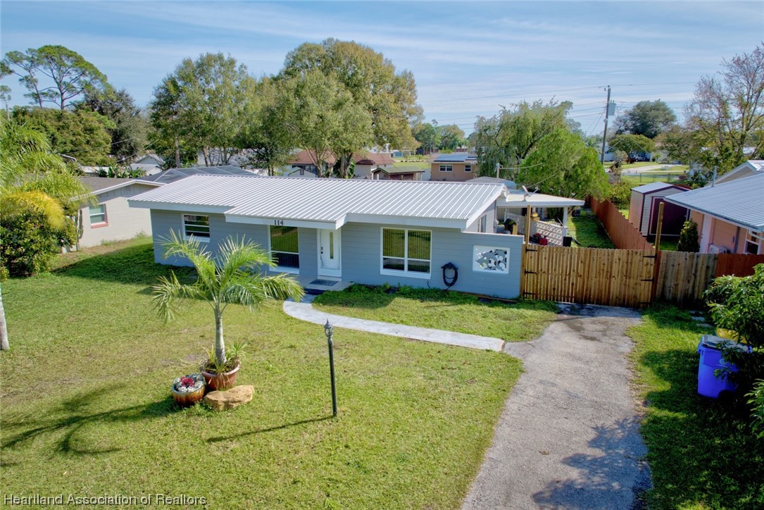 114 Spring Garden Road Sebring, FL 33870 - Photo 1 of 34 a house view with a garden space