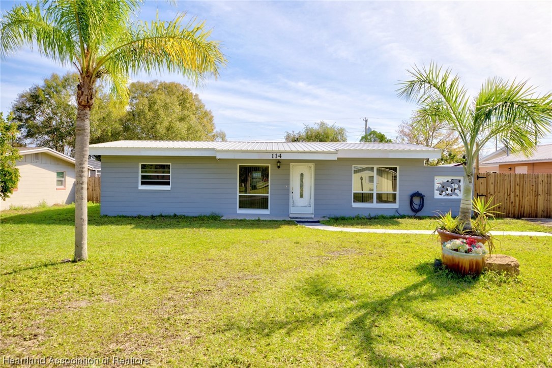 114 Spring Garden Road Sebring, FL 33870 - Photo 2 of 34 a front view of house with yard and seating area