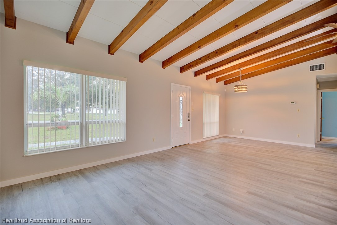 114 Spring Garden Road Sebring, FL 33870 - Photo 27 of 34 a view of an empty room with wooden floor and windows