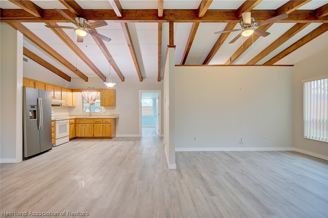 114 Spring Garden Road Sebring, FL 33870 - Photo 28 of 34 a view of a big room with wooden floor and windows