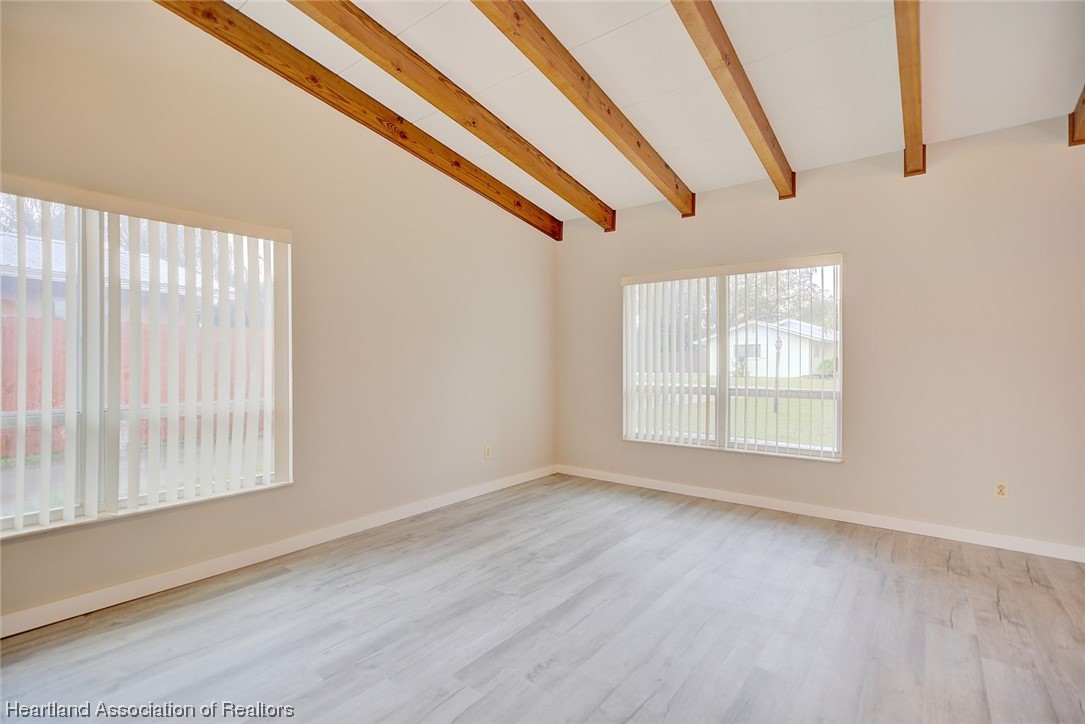 114 Spring Garden Road Sebring, FL 33870 - Photo 30 of 34 a view of an empty room with wooden floor and windows