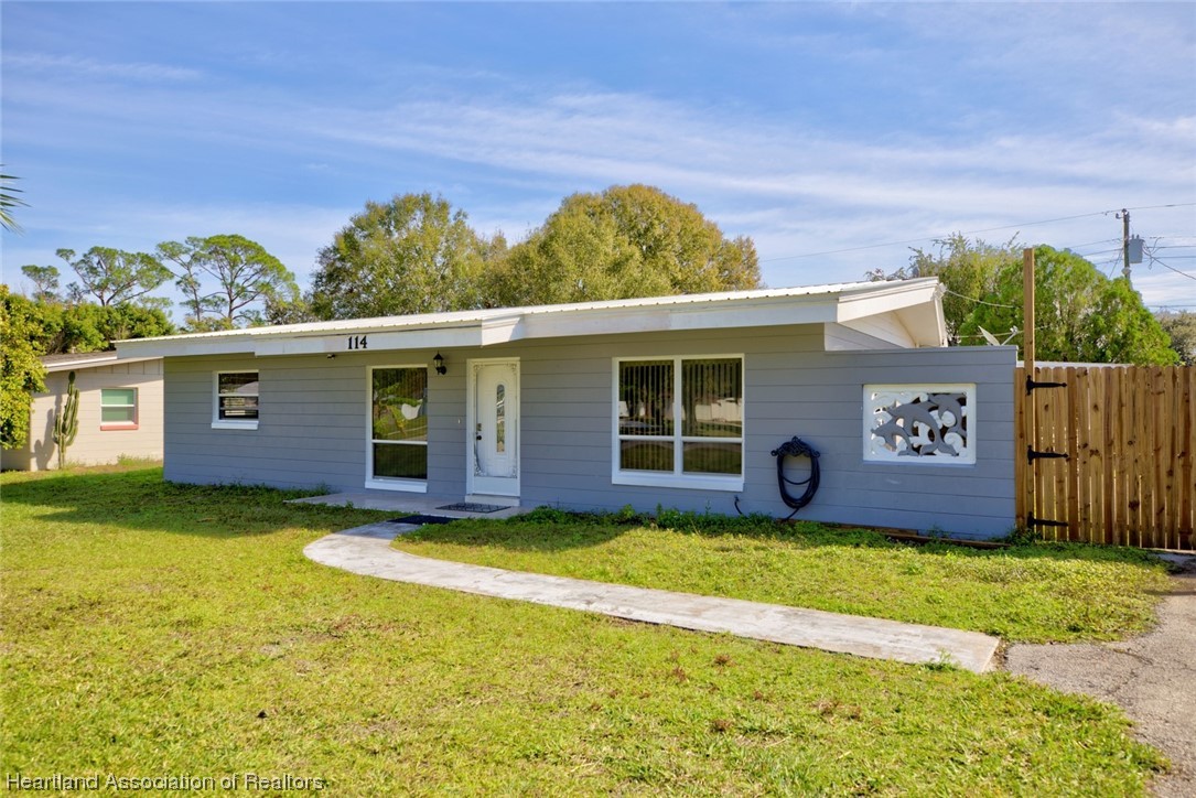 114 Spring Garden Road Sebring, FL 33870 - Photo 3 of 34 a view of a house with a yard