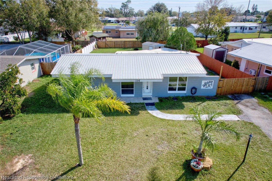 114 Spring Garden Road Sebring, FL 33870 - Photo 32 of 34 a front view of a house with a yard table and chairs