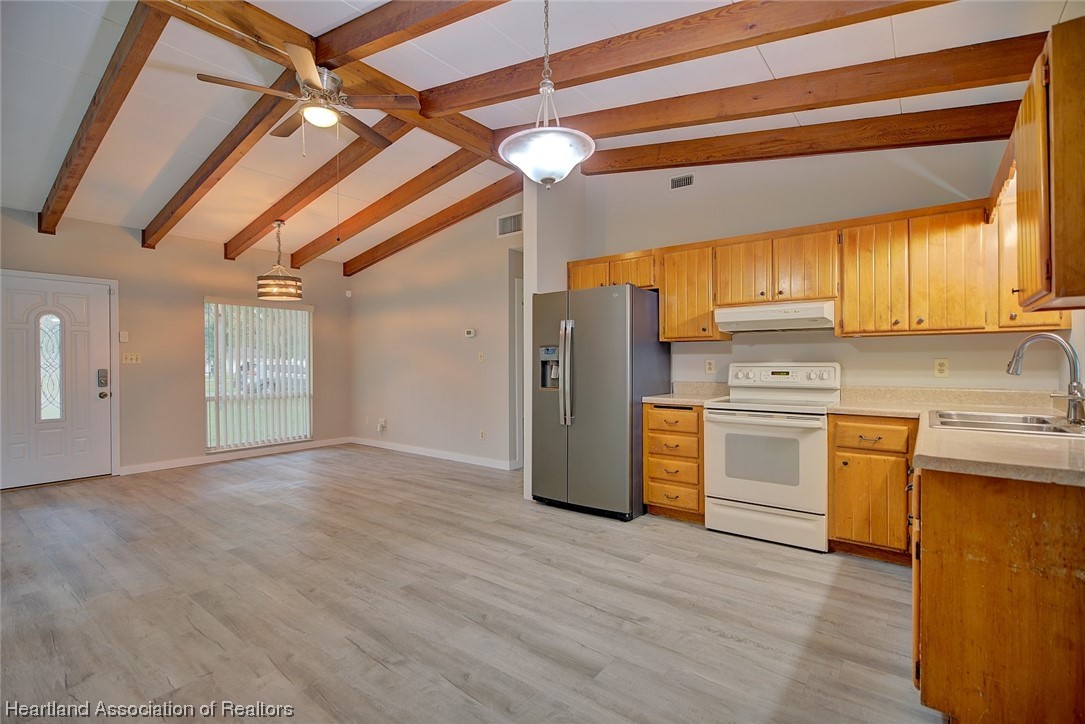 114 Spring Garden Road Sebring, FL 33870 - Photo 6 of 34 a kitchen with refrigerator cabinets and wooden floor