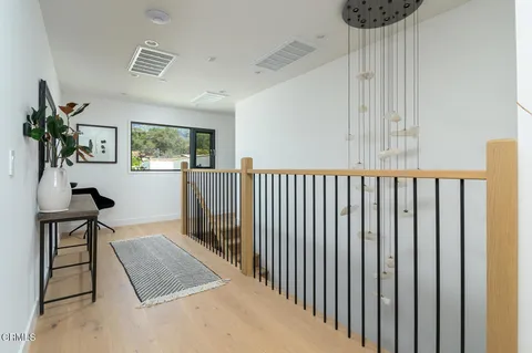 a view of a livingroom with furniture and staircase