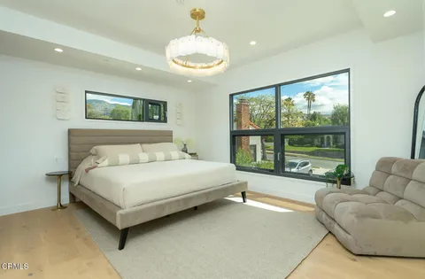 a spacious bedroom with a bed and a large window