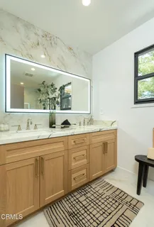 a spacious bathroom with a double vanity sink and a mirror