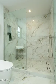 a bathroom with a toilet and a shower