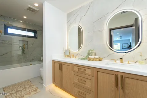 a bathroom with a double vanity sink and a mirror