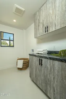 a close view of a sink a stove and cabinets in a room