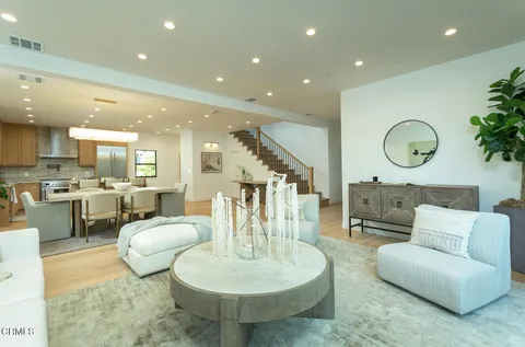 a living room with furniture and kitchen view