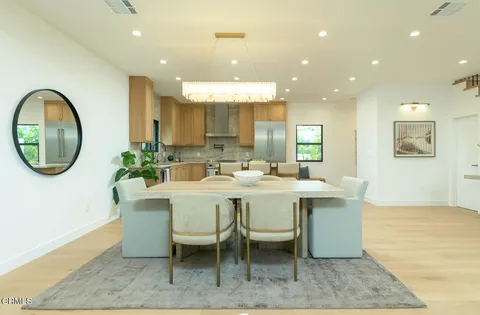a dining room with kitchen island a table and chairs