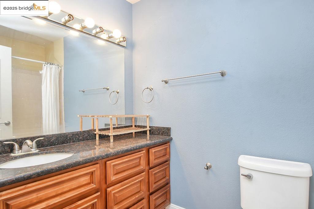 1699 Laguna Street, Unit 311 Concord, CA 94520 - Photo 18 of 29 a bathroom with a granite countertop sink and a mirror
