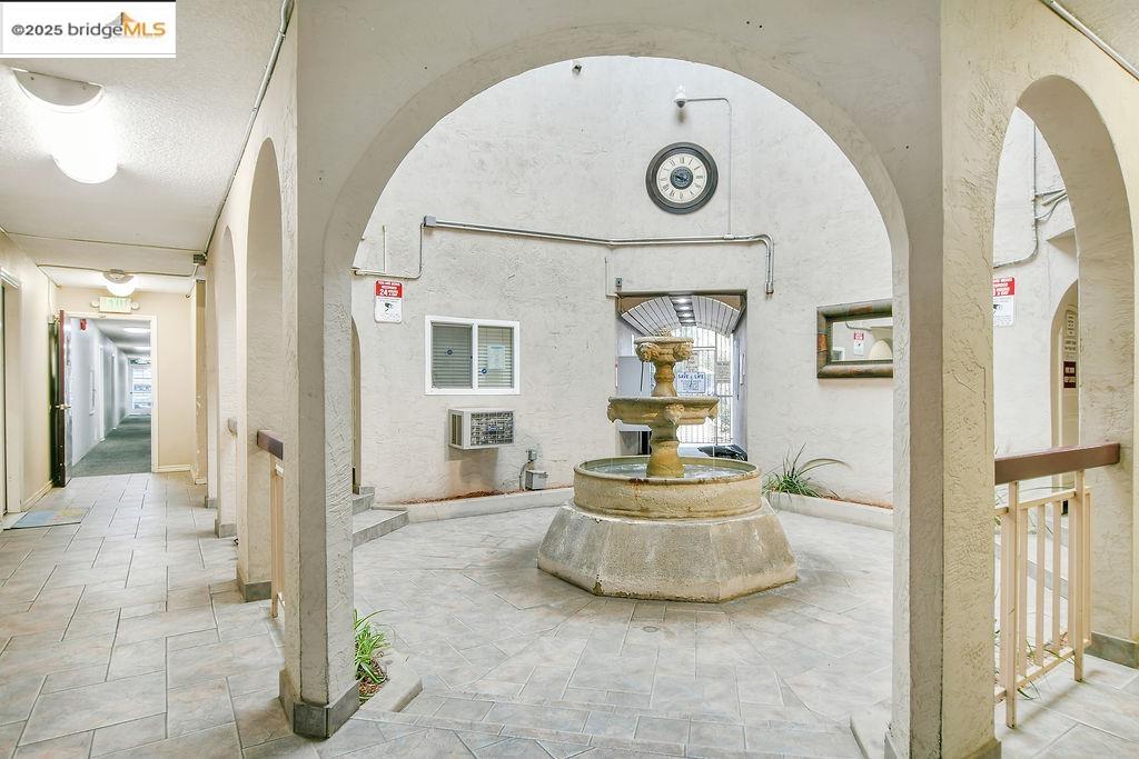 1699 Laguna Street, Unit 311 Concord, CA 94520 - Photo 4 of 29 a view of a hallway with a dining table and chandelier