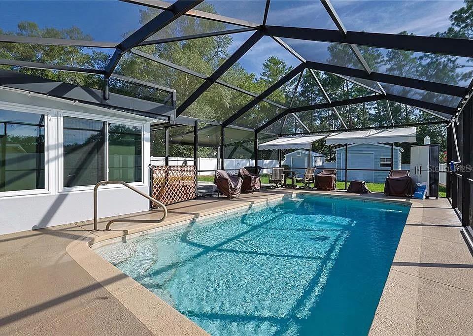 6367 Southwest 117th St Road Ocala, FL 34476 - Photo 18 of 22 a view of a patio with a table and chairs